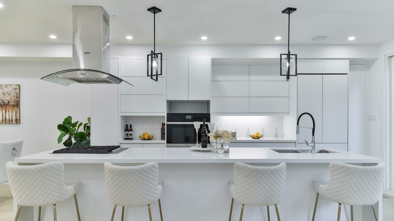 a kitchen with a center island with four bar stools